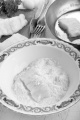 cod filet on wooden board and in flour placed