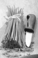chives and a small kitchen knife on a wooden board