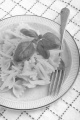 home made farfalle with parmesan cheese and basil on a plate