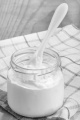 home made yogurt in a glass with white spoon