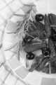 black olive, rosemary and sun dried tomatoes on a plate