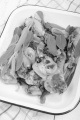 grilled chicken leg with sage in an enamel bowl