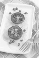 cucumber salad with tomato, olive oil and spring onion on a white plate