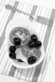 cucumber salad with tomato, black olive and crushed pepper in a white bowl
