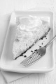 cheese cake with whipped cream and lemon on a plate