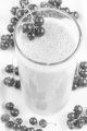 milkshake with organic red currants on a white table
