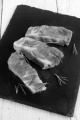 raw ribs with rosemary on slate plate