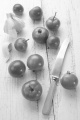 organic tomato on an old wooden table with garlic and knife