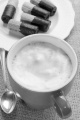 freshly boiled coffee with milk froth and biscuits on a small plate
