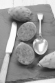 cactus figs cut ??with knife and spoon on slate