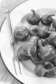 green cherry peppers and fork on a white enamel plate