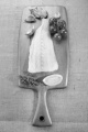 raw cod fillet with garlic, tomato, thyme and lemon on wooden board