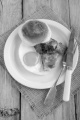 british breakfast muffin with fried egg, grilled bacon and parsley