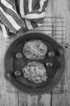 home made black pudding boxty in a cast iron pan with cherry tomato