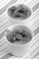 creme brulee with blueberries and mint in a white bowl