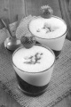 strawberry dessert in a glass with vanilla froth on jute