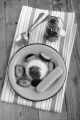 panna cotta with fresh plum, sauce, mint and biscuit on a blue plate