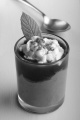 chocolate mascarpone dessert with strawberry mousse, whipped cream, cocoa powder and mint  in a shot glass  