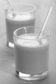 carrot and turnip smoothie with straw in a shot glass