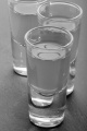 woodruff vodka drink in a shot glass on slate