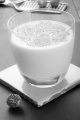 whisky milk cocktail with grated nutmeg in a glass on slate