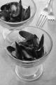 warm mussel with tomato sauce in a cocktail glass