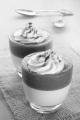 strawberry mousse with pudding, whipped cream and cocoa powder in a glass