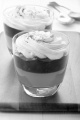dessert with orange jelly, fruit mix and whipped cream with cocoa powder