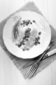 herring with sour cream, pomegranate seed and dill on a plate