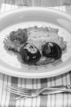 potato pancake with bramble jam and parsley on a plate