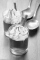 strawberry jelly with whipped cream and cocoa powder in a shot glass
