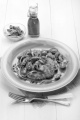 mediterranean potato pancake with mussel, green olive, thyme, plum tomato, olive oil and purple onion on a plate