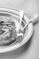 vegetarian potato pancake with bell pepper and lilac onion on a plate