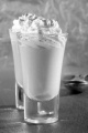 butterscotch made from brown sugar and butter with whipped cream and cocoa powder in a shot glass