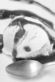 vanilla yogurt ice cream with strawberry mousse and spoon on a white plate