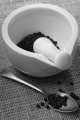 mortar and pestle with black pepper and spoon on jute