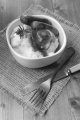 irish sausage, mashed potato and rosemary with onion gravy in a bowl on jute