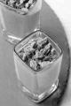 chocolate mousse and broken chocolate in a shot glass on round slate