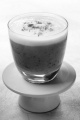 chocolate mousse with vanilla cream and cocoa powder in a glass