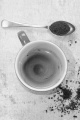 freshly brewed instant coffee in a cup, some powder on spoon and wood