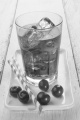 ice cold cherry juice and freshly washed cherries on a plate