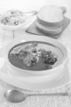 hungarian carp soup with sour cream in a white soup plate